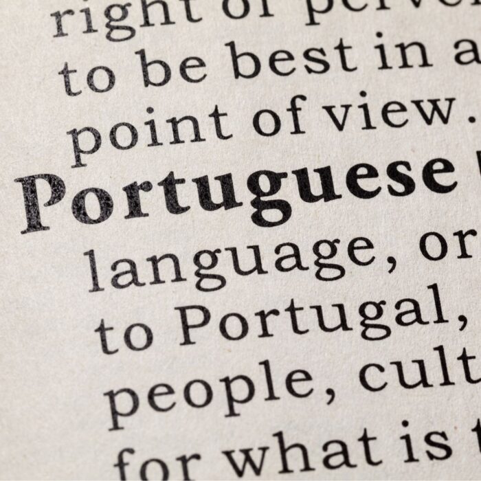 A stock image depicting a part of a book with the word Portuguese inprint among other words.