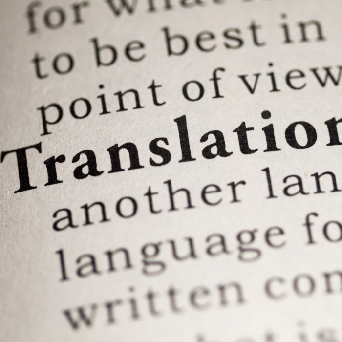 A stock image depicting a part of a book with the word Translation inprint among other words.